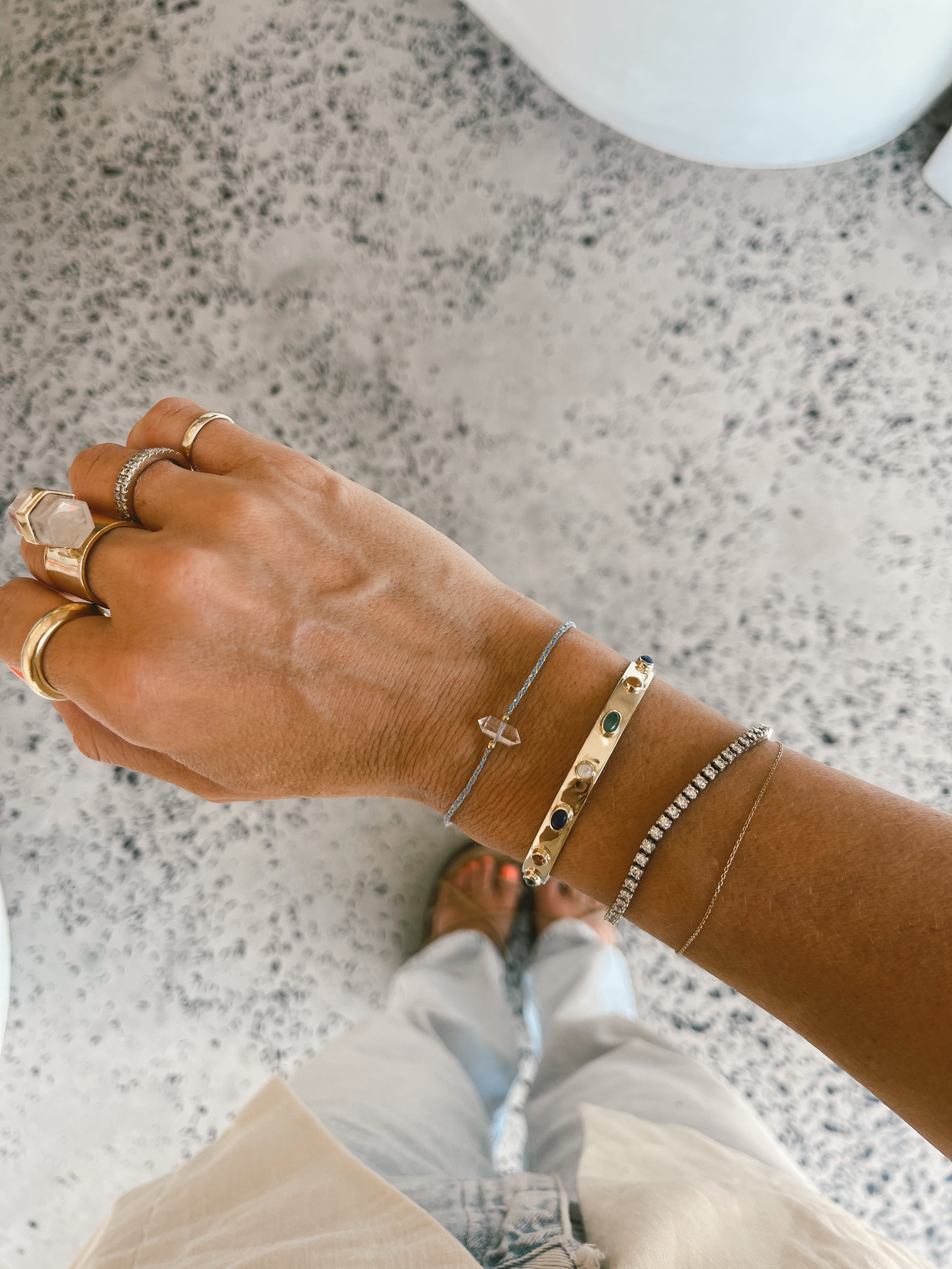 braided bracelet stacked with multi crystal bracelets